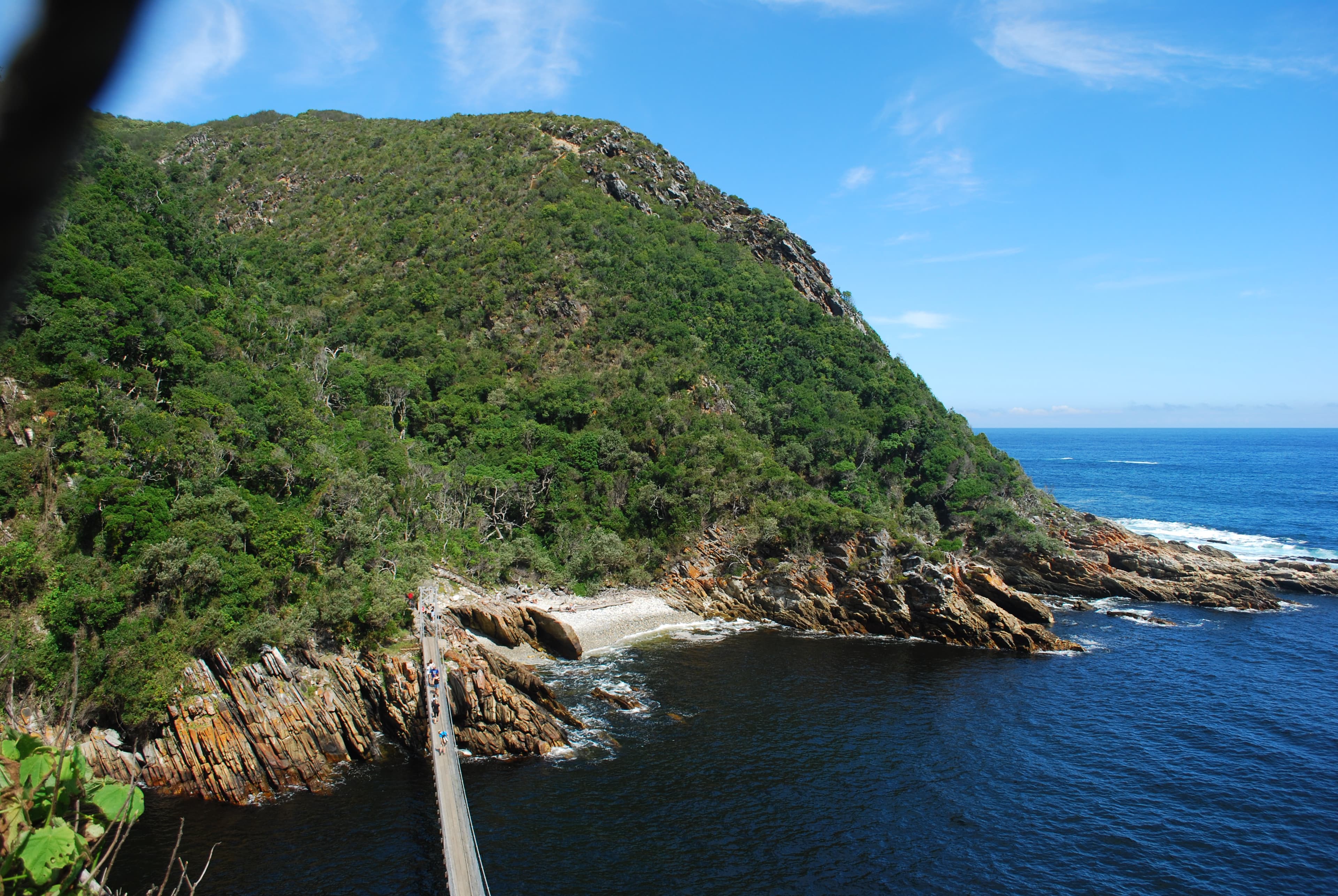 The Storms River Mouth suspension bridge crossing the river gorge in Tsitsikamma, Garden Route National Park, South Africa.